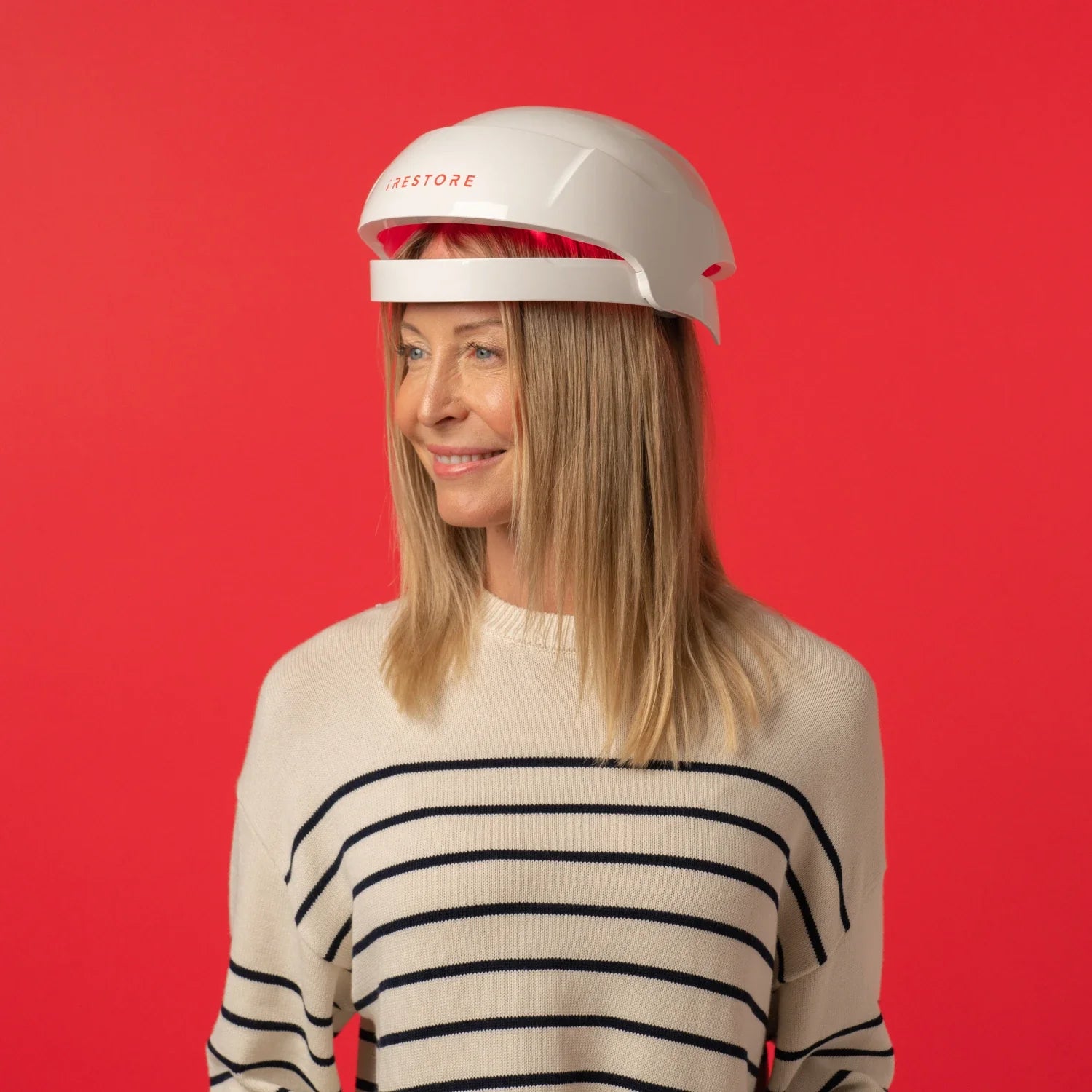 Image of a mature woman wearing the Essential hair device in side view angle.